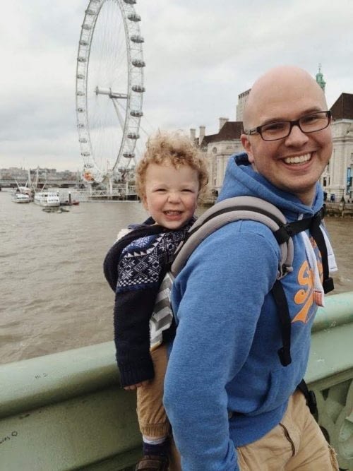 A dad back carrying a toddler in London