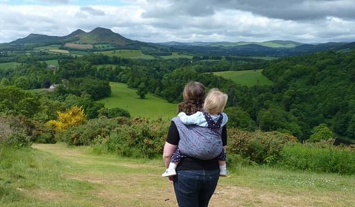 Carry Me Round sling walk with view of the Eilidons